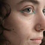 Primo piano di un makeup neon delicato per occhi, con solo l'eyeliner colorato in punti strateggici dell'occhio per enfatizzarne la forma