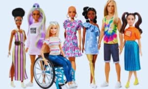 Una foto su sfondo bianco di tutte le nuove bambole Barbie. Per prima da sinistra c'è la Barbie con la vitiligine e i capelli ricci, subito dopo con lunghi capelli colorati, a seguire sulla sedia a rotelle, poi senza capelli, di colore con una protesi alla gamba, Ken con i capeli lunghi e in fine una bambola dai tratti asiatici
